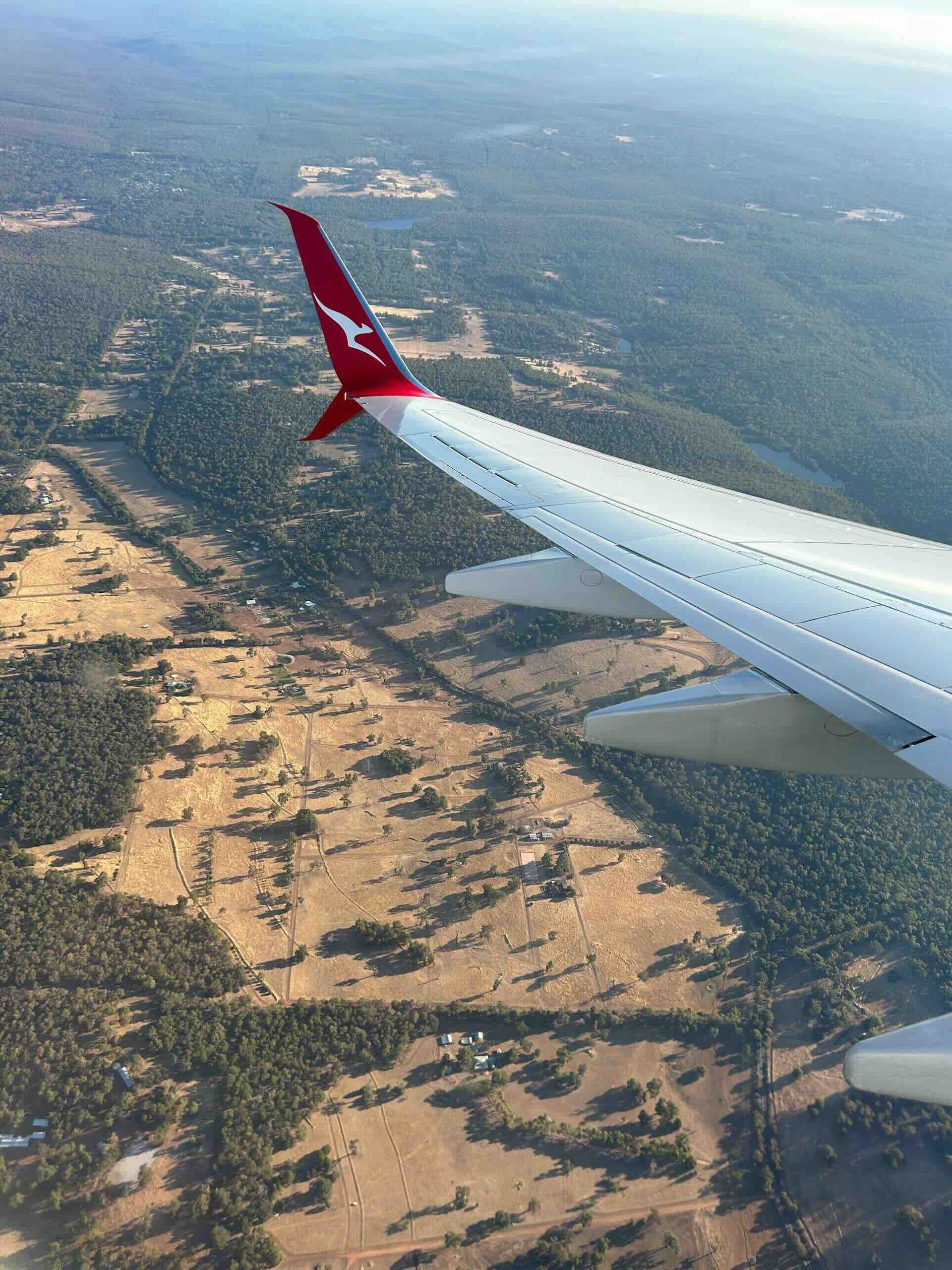 Wing of Qantas aeroplane flying over Western Australia.